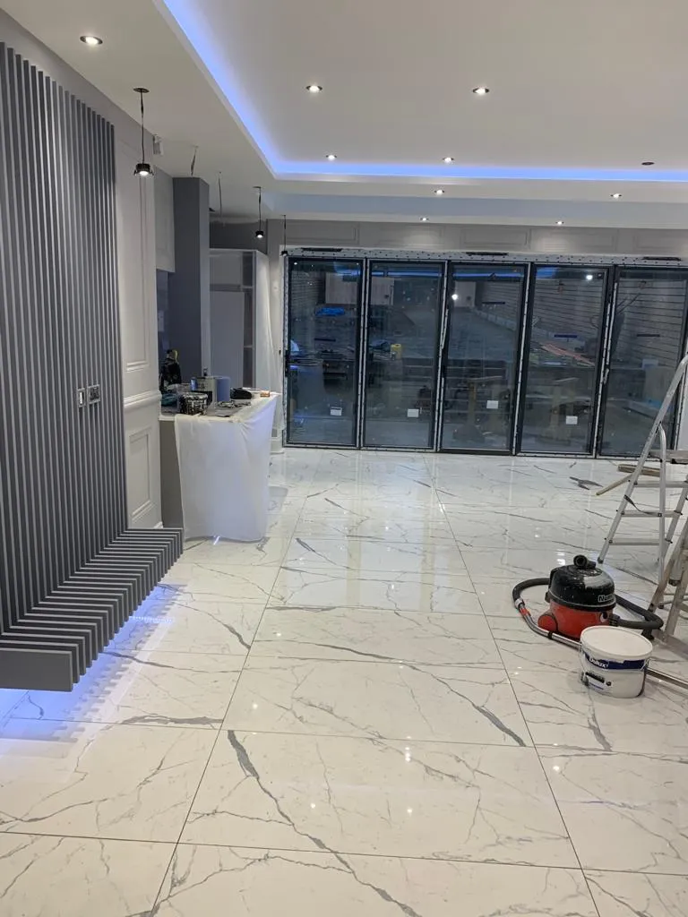 Interior building work with wide glazed doors and a newly finished floor